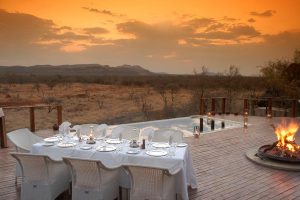 Luxury safari dinner with makuti arm chairs.