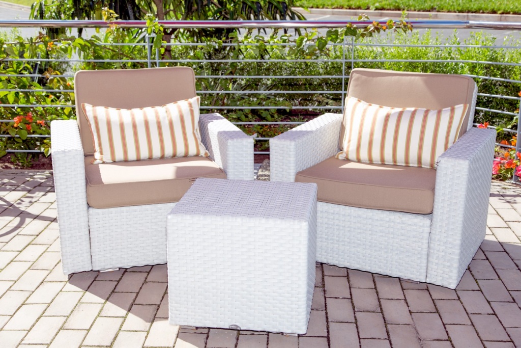 Two Mellisa arm chairs with cushions and an ottoman