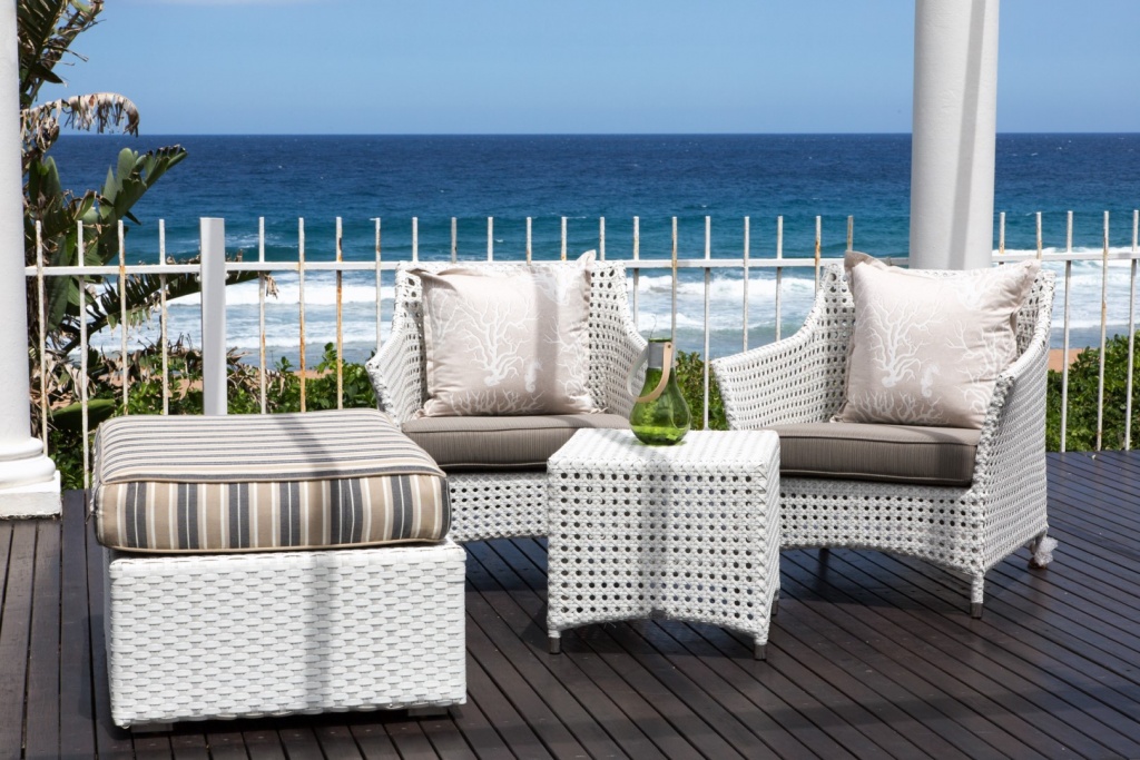 All weather outdoor Elita armchair and ottomans.