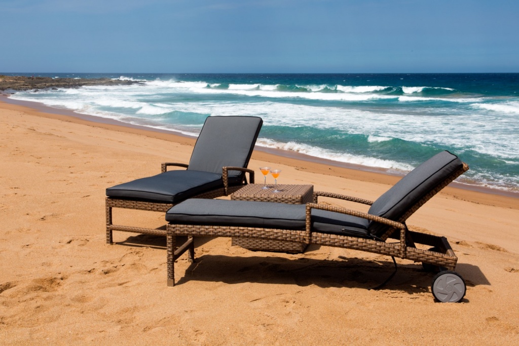 All weather outdoor loungers with wheels and adjustable back plus ottoman.