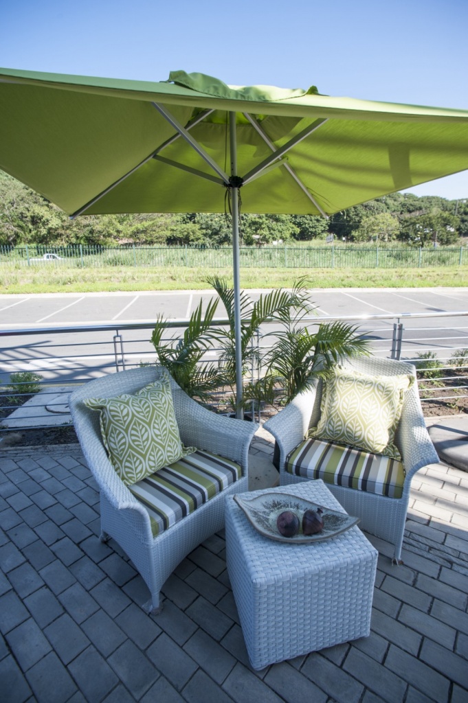 Two makuti armchairs and an ottoman.